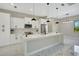 A gourmet kitchen with marble countertops, stainless steel appliances, and a large center island at 212 Fairway Rd, Rotonda West, FL 33947