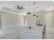 Bright, modern kitchen features white marble floors, a spacious island, and stylish pendant lighting at 212 Fairway Rd, Rotonda West, FL 33947