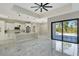 Open-concept kitchen and living area with marble floors and views of the outdoor pool at 212 Fairway Rd, Rotonda West, FL 33947