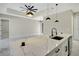Elegant kitchen island with marble countertop, black faucet, and pendant lights at 212 Fairway Rd, Rotonda West, FL 33947