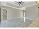 Spacious living room with marble floors, a modern ceiling fan, and an open layout design at 212 Fairway Rd, Rotonda West, FL 33947