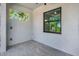 This covered patio features tiled floors and a bright view from the window, ready for your personal touch at 212 Fairway Rd, Rotonda West, FL 33947