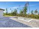 Unfinished pool with tile accents surrounded by a brick patio and lush landscaping at 212 Fairway Rd, Rotonda West, FL 33947