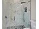 Frameless shower with a black rainfall shower head, handheld wand, and tiled floors at 212 Fairway Rd, Rotonda West, FL 33947