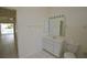 Bathroom with vanity, toilet, and view to pool area through doorway at 515 Allworthy St, Port Charlotte, FL 33954