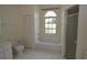 Bright bathroom featuring a tub with window, shower and storage closet at 515 Allworthy St, Port Charlotte, FL 33954