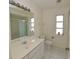 Well-lit bathroom with a sink vanity, shower, and mirror at 515 Allworthy St, Port Charlotte, FL 33954