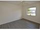 Bedroom with new flooring, ceiling fan and natural lighting from the window at 515 Allworthy St, Port Charlotte, FL 33954