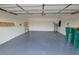 Spacious garage with epoxy flooring and ample storage, perfect for vehicles and home projects at 515 Allworthy St, Port Charlotte, FL 33954