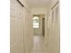 Hallway leading to bathroom with shower, tub and natural light window at 515 Allworthy St, Port Charlotte, FL 33954
