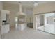 Open kitchen with white appliances, tile flooring and adjacent living spaces at 515 Allworthy St, Port Charlotte, FL 33954