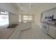 Bright kitchen with stainless appliances, tile floor, breakfast bar and views to the pool at 515 Allworthy St, Port Charlotte, FL 33954