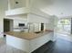 Open kitchen design with white cabinets, laminate counters, and a breakfast bar area at 515 Allworthy St, Port Charlotte, FL 33954