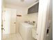 Bright laundry room featuring a washer, dryer, and ample storage space for added convenience at 515 Allworthy St, Port Charlotte, FL 33954