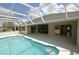 A stunning screened-in pool with a large deck, ideal for entertaining guests or relaxing outdoors at 515 Allworthy St, Port Charlotte, FL 33954