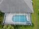 Aerial view of a private screened-in pool with surrounding tile patio and clear blue water at 515 Allworthy St, Port Charlotte, FL 33954