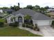 Single-story house with gray roof and landscaped yard at 515 Allworthy St, Port Charlotte, FL 33954