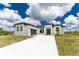 Modern two-story house with a large driveway at 9526 Rosebud Cir, Port Charlotte, FL 33981