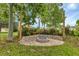 Charming fire pit area with brick seating and landscaping at 16195 Maya Cir, Punta Gorda, FL 33955