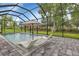 Relaxing screened pool area with in-pool loungers and umbrella at 16195 Maya Cir, Punta Gorda, FL 33955