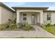 Exterior view showing the front entrance with a covered porch and landscaped walkway at 16195 Maya Cir, Punta Gorda, FL 33955