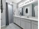 Bathroom with double vanity, shower, and tile flooring at 16195 Maya Cir, Punta Gorda, FL 33955