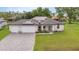 Two-car garage, solar panels, and nicely landscaped yard at 16195 Maya Cir, Punta Gorda, FL 33955