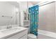 Bathroom with tub shower combo, white vanity, and colorful shower curtain at 16195 Maya Cir, Punta Gorda, FL 33955
