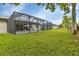 Screened pool and patio area with spacious grassy yard at 16195 Maya Cir, Punta Gorda, FL 33955