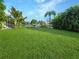 Grass, tropical plants and canal view with boats at 695 Coronado Dr, Punta Gorda, FL 33950