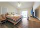 Spacious bedroom with king-size bed, nightstand and sliding glass door to patio at 695 Coronado Dr, Punta Gorda, FL 33950