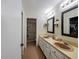 Bathroom with double sinks, large mirrors, and shower at 695 Coronado Dr, Punta Gorda, FL 33950