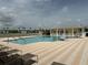 Community pool with lounge chairs and surrounding homes at 2140 Heron Lake Dr # 204, Punta Gorda, FL 33983