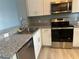 Stainless steel appliances and granite countertops in kitchen at 2140 Heron Lake Dr # 204, Punta Gorda, FL 33983