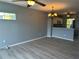 Living room features a chandelier and laminate flooring at 2140 Heron Lake Dr # 204, Punta Gorda, FL 33983