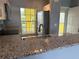 Granite countertop kitchen with stainless steel appliances at 2140 Heron Lake Dr # 204, Punta Gorda, FL 33983