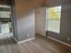 Bedroom with wood-look floors and view of kitchen at 2140 Heron Lake Dr # 204, Punta Gorda, FL 33983