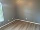 Spacious bedroom with wood-look floors and window at 2140 Heron Lake Dr # 204, Punta Gorda, FL 33983