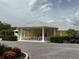 Community clubhouse with covered entrance and landscaping at 2140 Heron Lake Dr # 204, Punta Gorda, FL 33983
