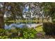 Waterfront view of community with lush landscaping at 2140 Heron Lake Dr # 204, Punta Gorda, FL 33983