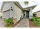 One-story home with gray exterior, two-car garage, and welcoming front porch at 42186 Edgewater Dr, Punta Gorda, FL 33982