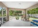 Relaxing screened porch with patio furniture overlooking backyard at 5272 Boxer St, North Port, FL 34288