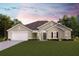 One-story home with a two-car garage and landscaping at 13395 High Springs Ave, Port Charlotte, FL 33981