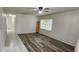 Living room with wood-look flooring and corner shelving at 426 Ricold Ter, Port Charlotte, FL 33954