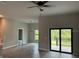 Bright living room featuring tile floors and sliding glass doors at 13460 Tolman Ave, Port Charlotte, FL 33953