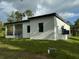 Rear view of a single-story house with a covered patio at 13460 Tolman Ave, Port Charlotte, FL 33953