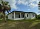 Modern house exterior with covered patio and yard at 13460 Tolman Ave, Port Charlotte, FL 33953