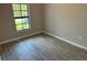 Well-lit bedroom with tile floors and a window at 13460 Tolman Ave, Port Charlotte, FL 33953