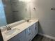 Double vanity bathroom with large mirror and tile floor at 13460 Tolman Ave, Port Charlotte, FL 33953