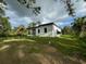 A modern, single-story house with a covered patio at 13460 Tolman Ave, Port Charlotte, FL 33953